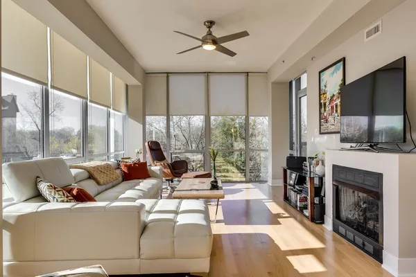 a living room with fireplace furniture and a flat screen tv