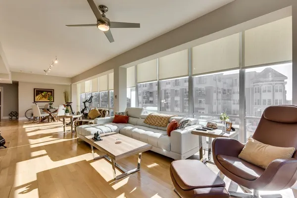 a living room with furniture city view and large windows
