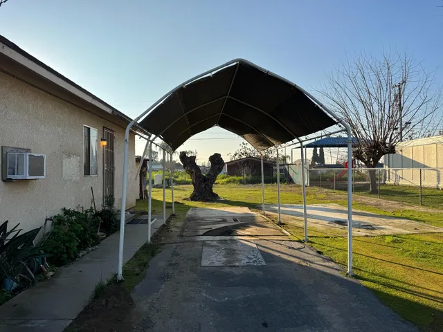 a view of a swimming pool with a lawn chairs under an umbrella
