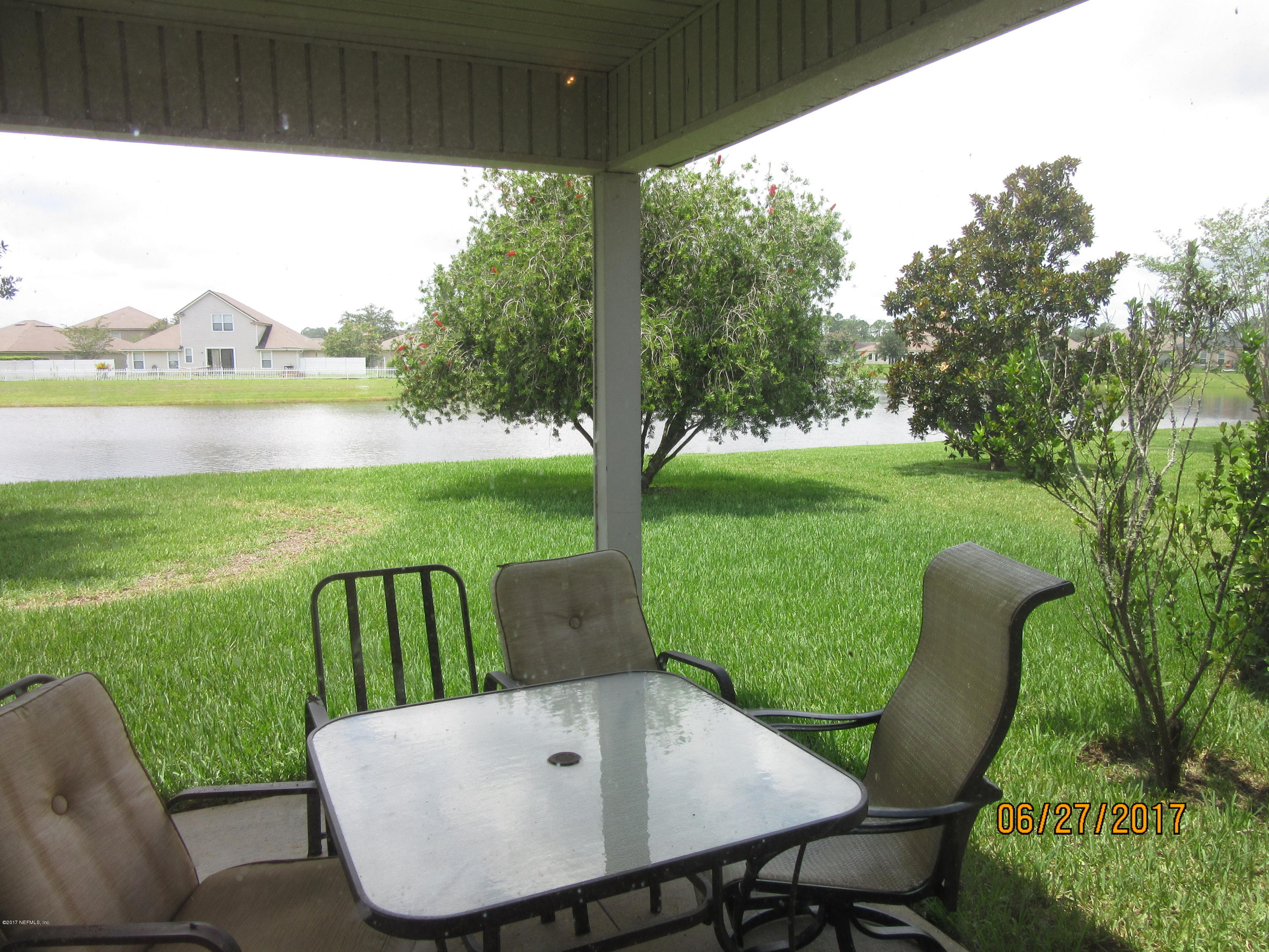 766 East Red House Branch Road St. Augustine, FL 32084 - Photo 14 of 15 a view of a patio with furniture and a yard