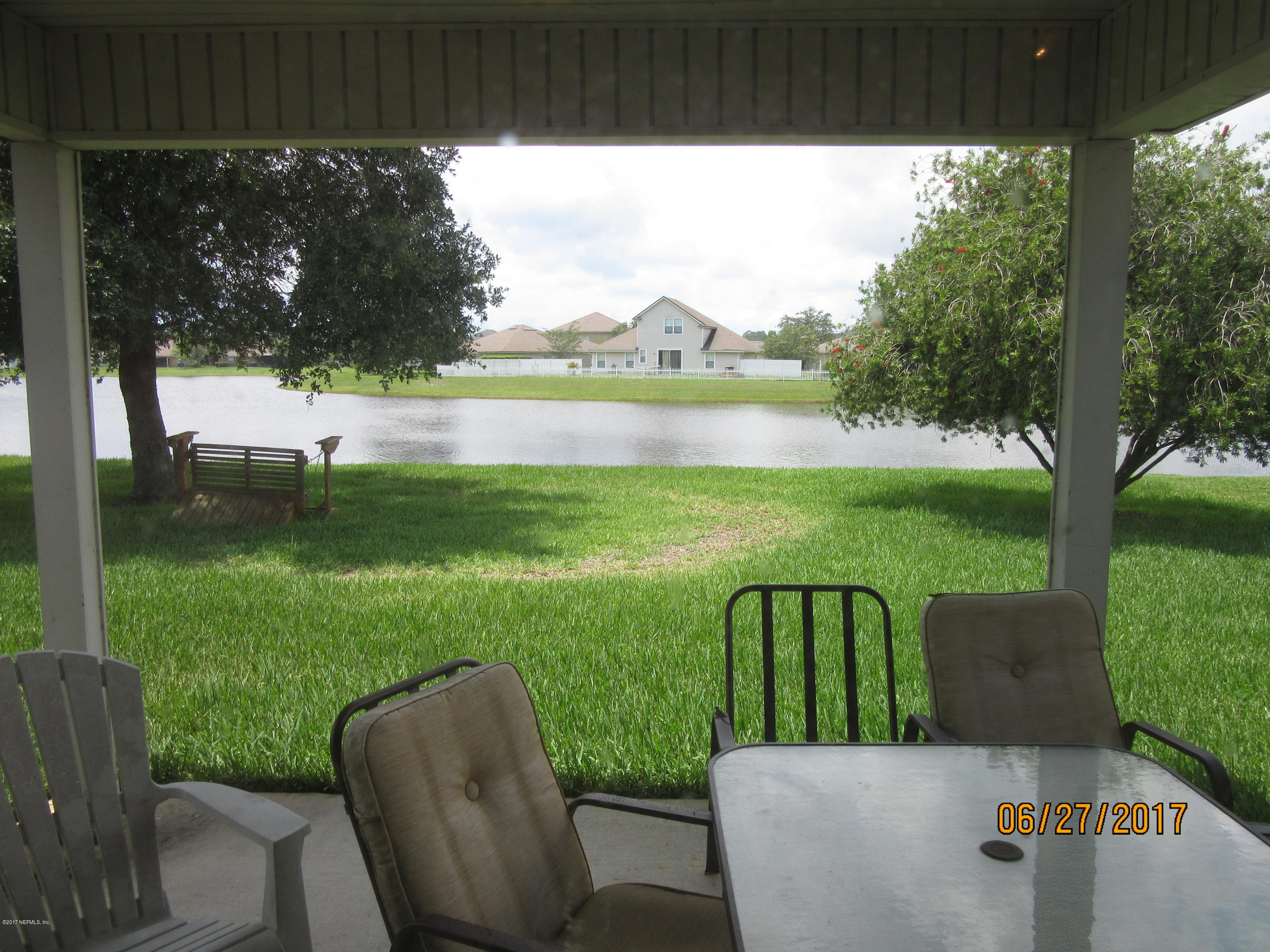 766 East Red House Branch Road St. Augustine, FL 32084 - Photo 5 of 15 a view of a two chairs and table in a yard