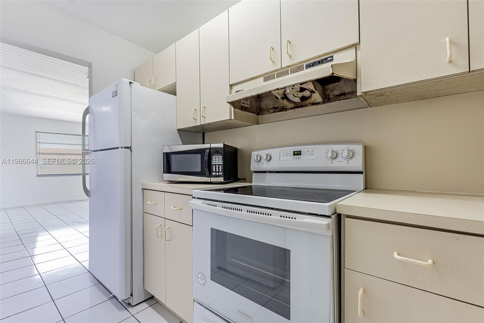a kitchen with stainless steel appliances white cabinets and a refrigerator