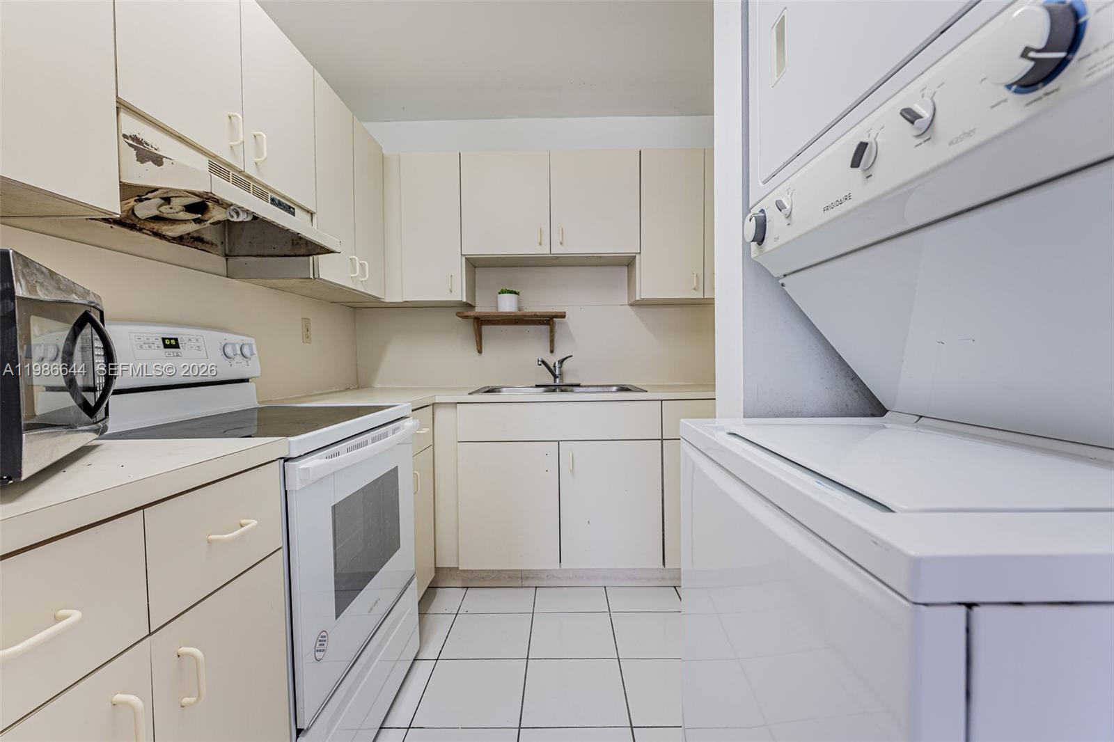 15260 Southwest 80th Street, Unit 10 Miami, FL 33193 - Photo 13 of 27 a kitchen with white cabinets and white appliances