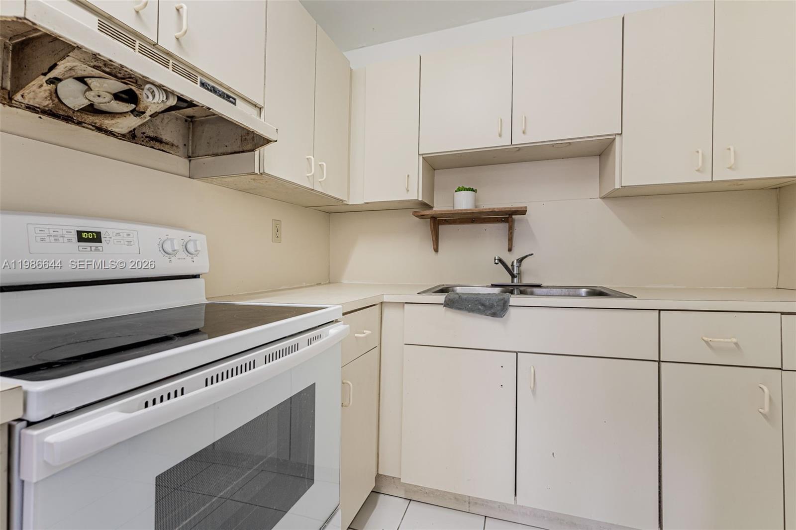 15260 Southwest 80th Street, Unit 10 Miami, FL 33193 - Photo 14 of 27 a kitchen with white cabinets and appliances