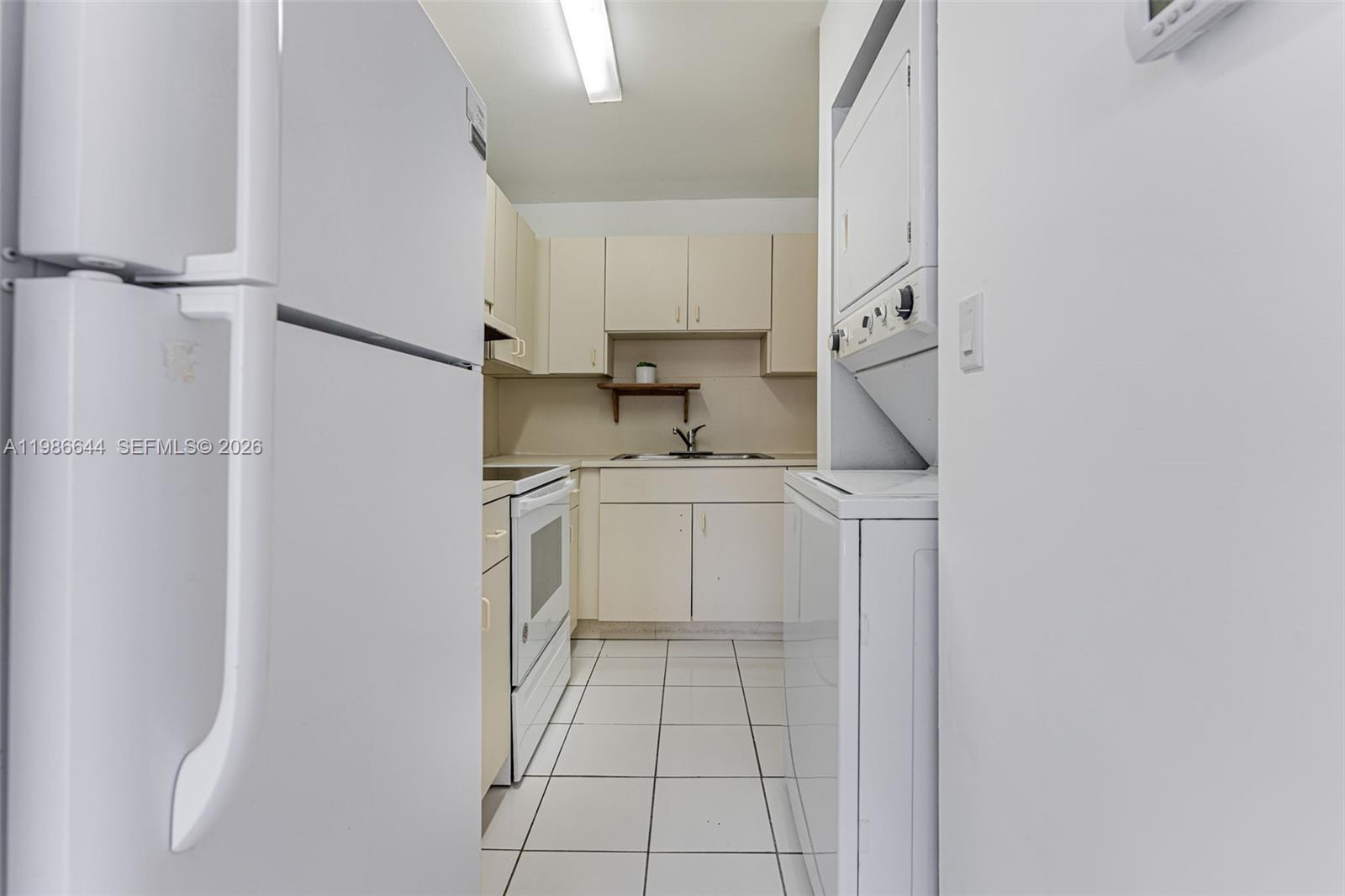 15260 Southwest 80th Street, Unit 10 Miami, FL 33193 - Photo 16 of 27 a utility room with cabinets washer and dryer