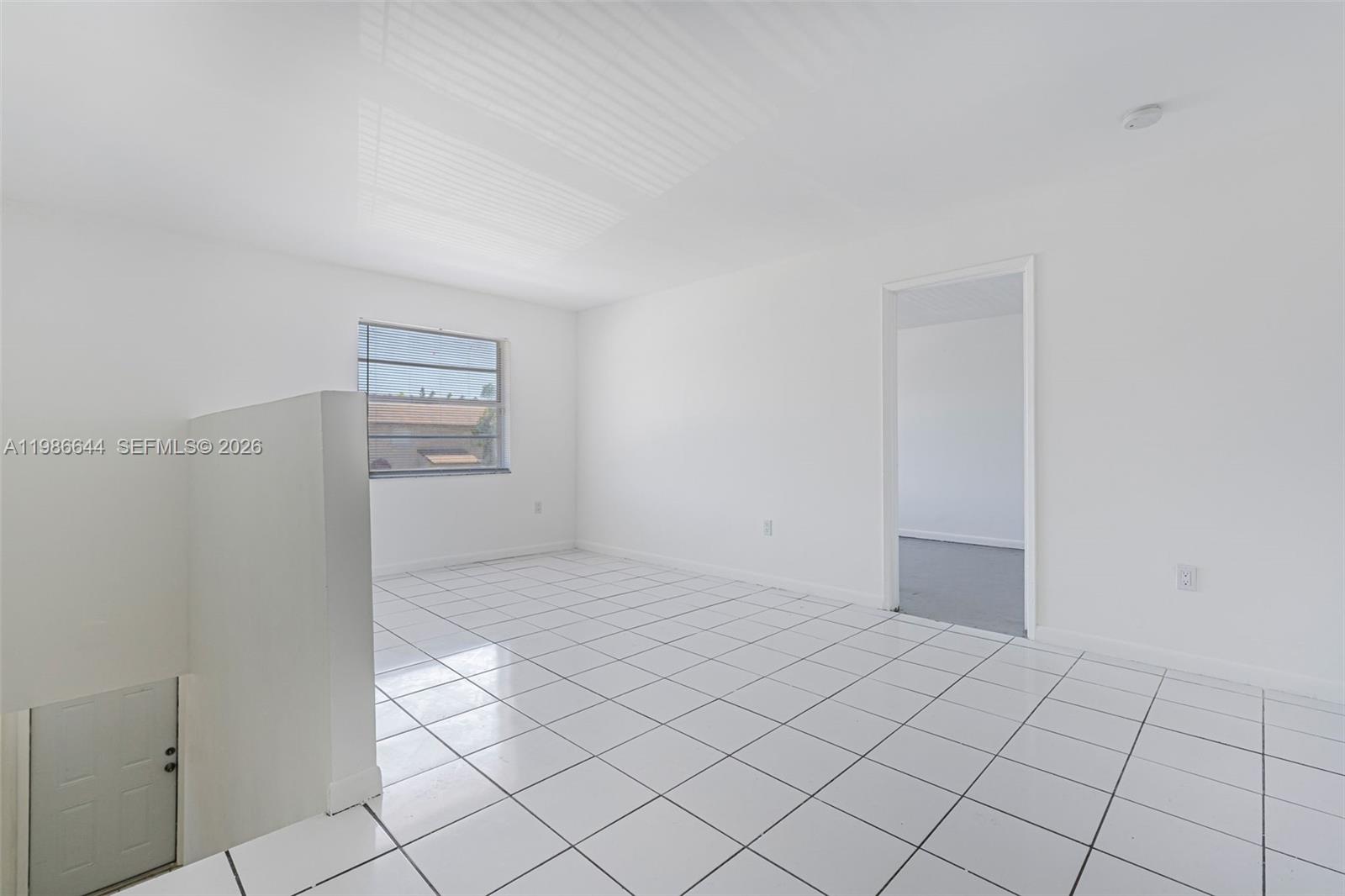 15260 Southwest 80th Street, Unit 10 Miami, FL 33193 - Photo 18 of 27 a view of an empty room and window