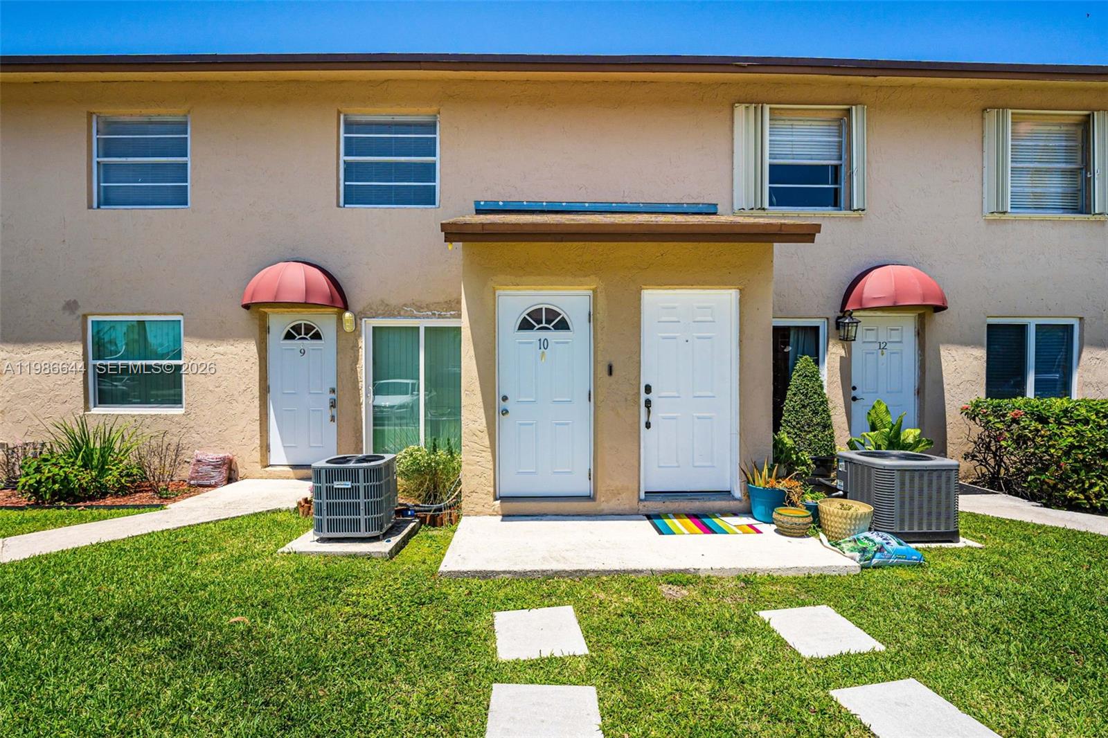 15260 Southwest 80th Street, Unit 10 Miami, FL 33193 - Photo 2 of 27 a front view of house with yard