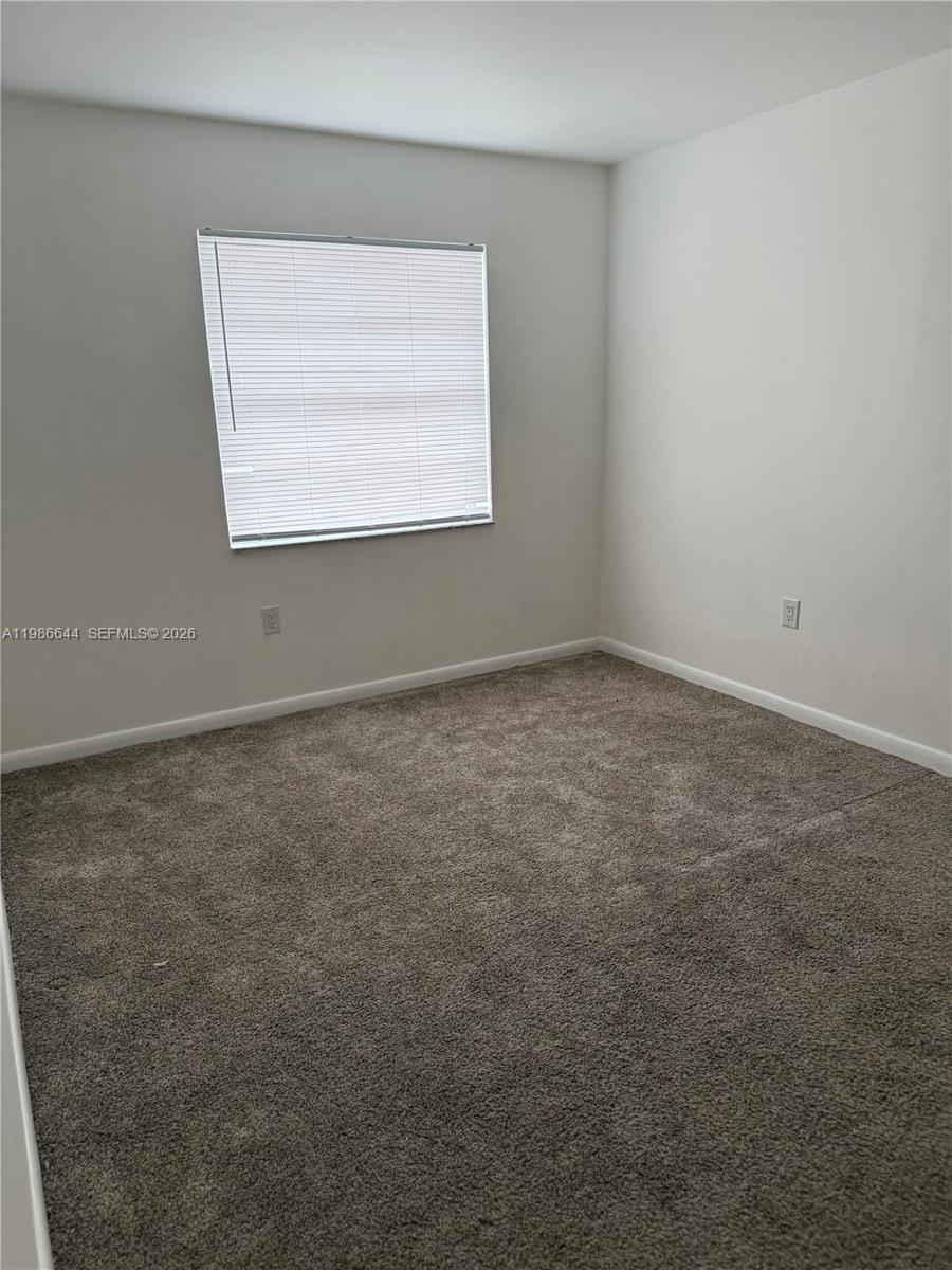 15260 Southwest 80th Street, Unit 10 Miami, FL 33193 - Photo 8 of 27 an empty room with a window