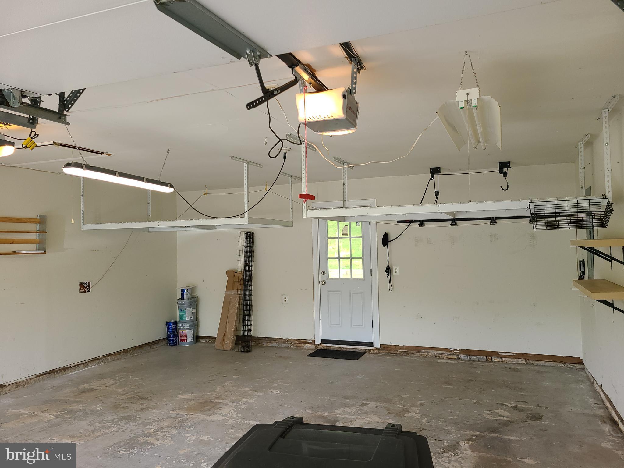8708 Oxwell Lane Laurel, MD 20708 - Photo 14 of 18 Two Car Garage featuring overhead shelf space.