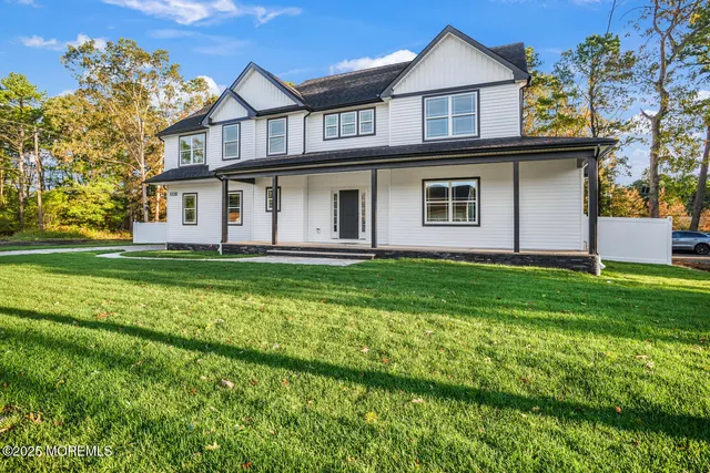 a front view of a house with a garden and yard
