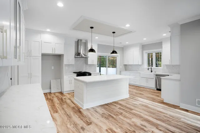 a kitchen that has a sink and a stove in it