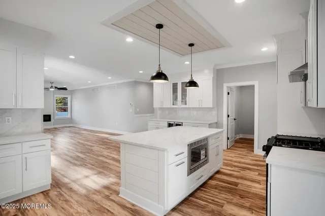 a kitchen with stainless steel appliances granite countertop a stove and a sink