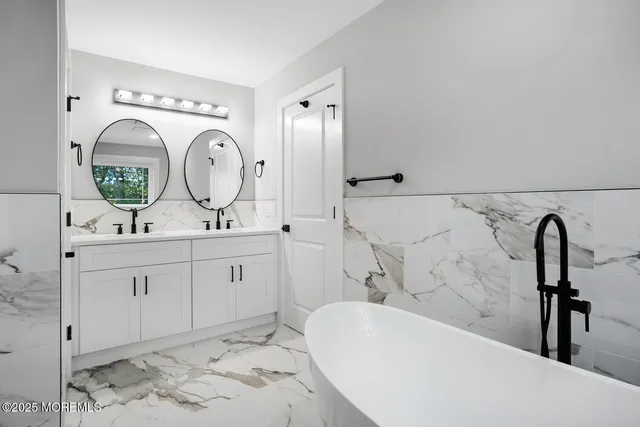 a bathroom with a toilet sink vanity and shower