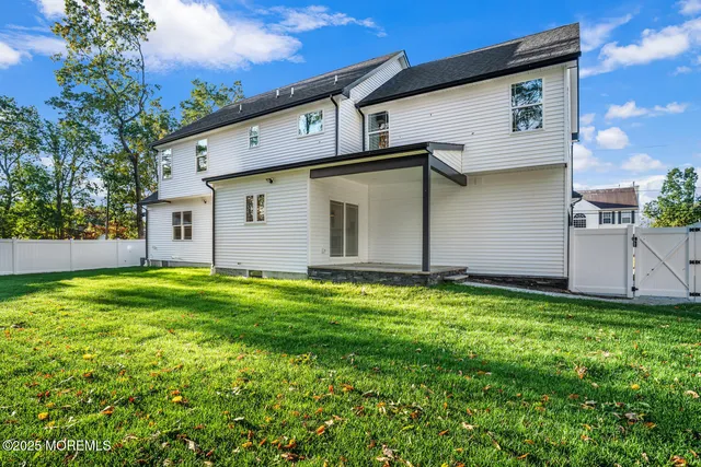 a view of a backyard with plants and large tree