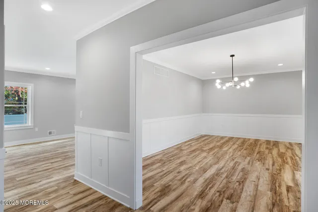 a view of entryway with wooden floor and stairs