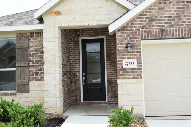 a front view of a house with a door and garage