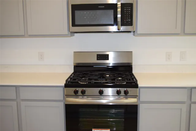 a stove top oven sitting inside of a kitchen