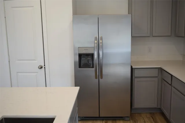a room with a refrigerator and cabinets