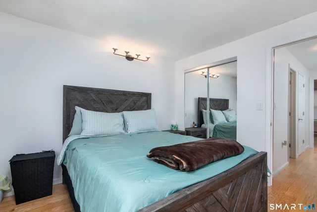 a bedroom with a bed and a night stand