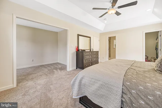 a view of a house with backyard and trees