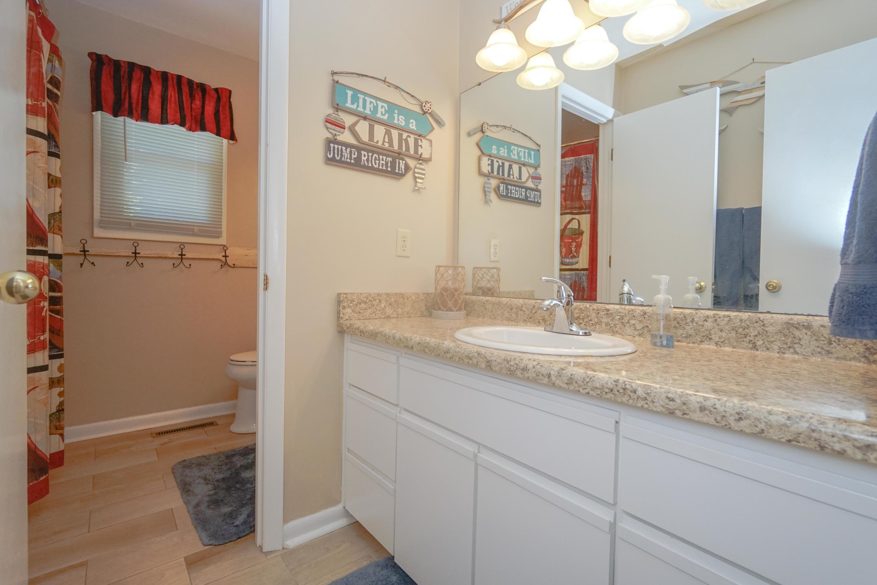 497 Cedar Ridge Road Union Hall, VA 24176 - Photo 16 of 31 a bathroom with a granite countertop sink and a mirror