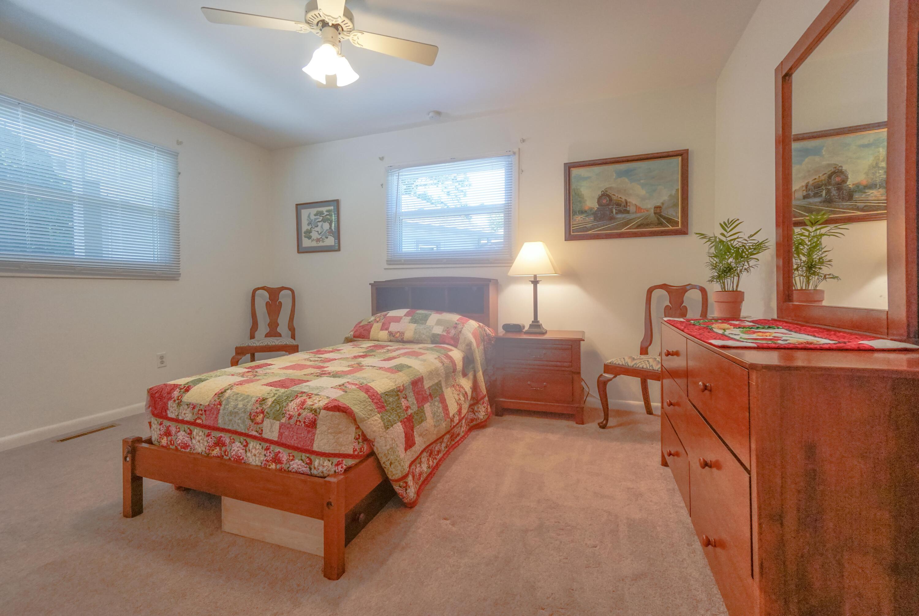 497 Cedar Ridge Road Union Hall, VA 24176 - Photo 17 of 31 a bedroom with a bed and a chandelier