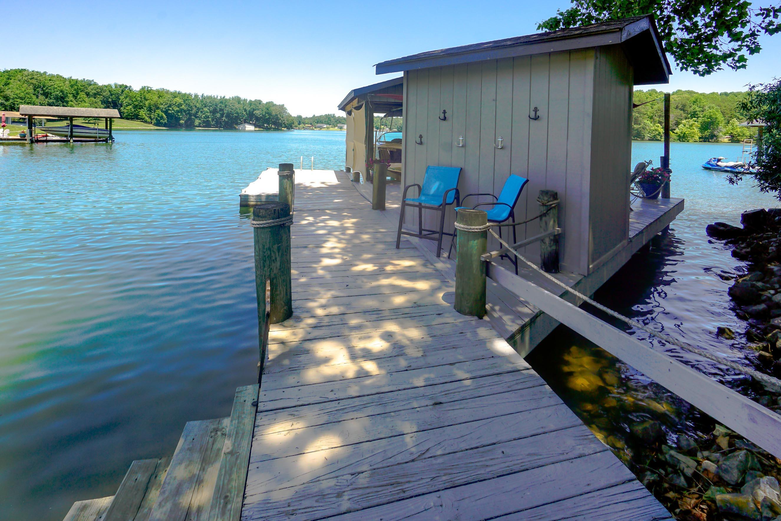 497 Cedar Ridge Road Union Hall, VA 24176 - Photo 4 of 31 a backyard of a house with wooden floor chairs and lake view