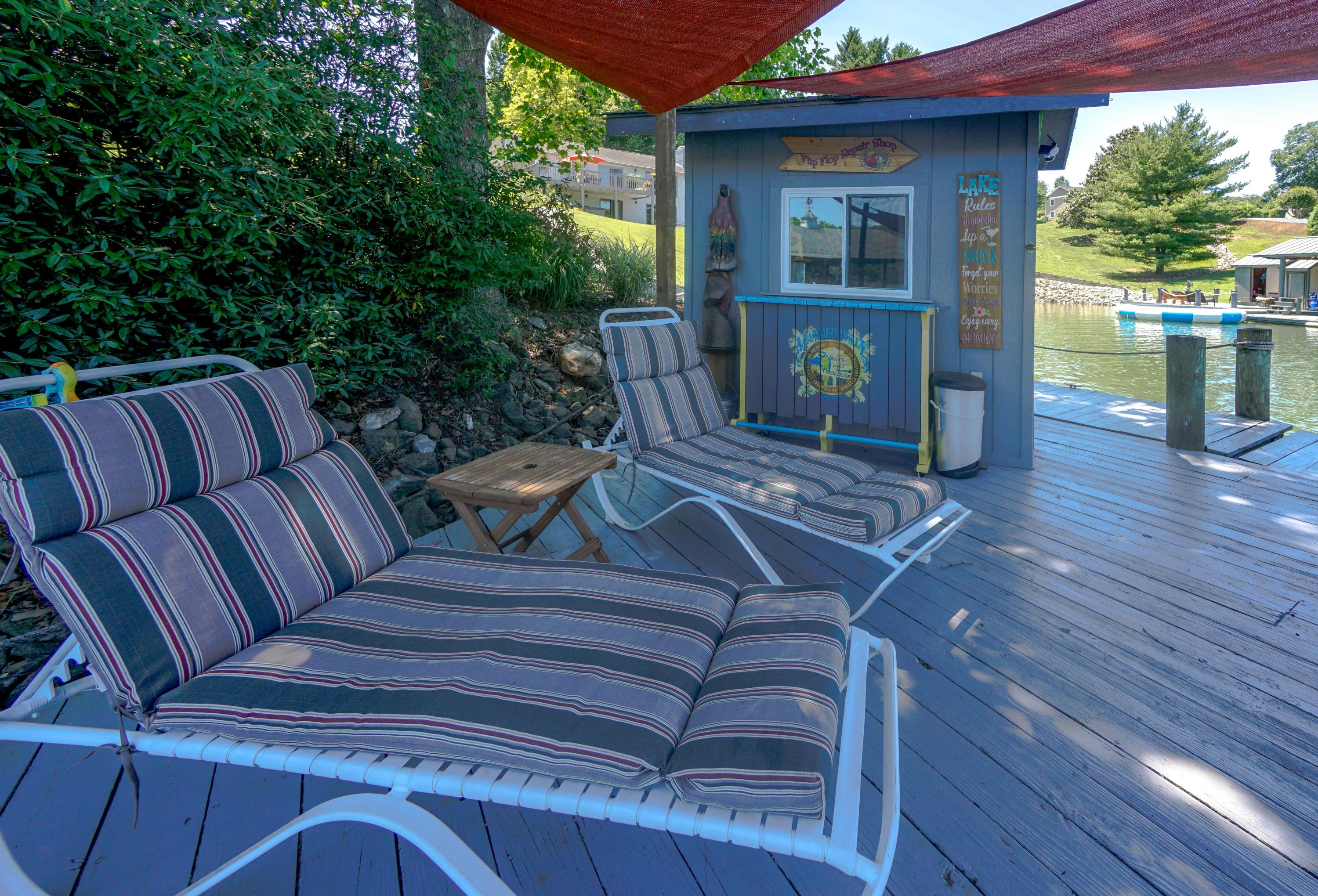 497 Cedar Ridge Road Union Hall, VA 24176 - Photo 5 of 31 a view of a deck with couches table and chairs with wooden floor and fence