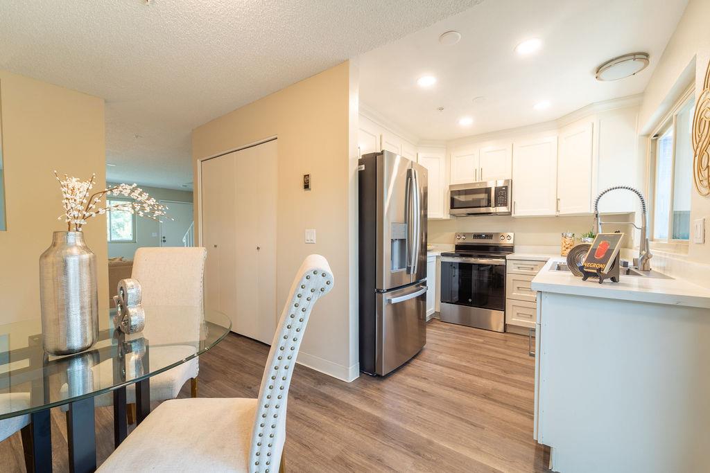 1005 Golf Course Drive Rohnert Park, CA 94928 - Photo 6 of 44 a kitchen with stainless steel appliances granite countertop a refrigerator a stove top oven a sink dishwasher and wooden floor