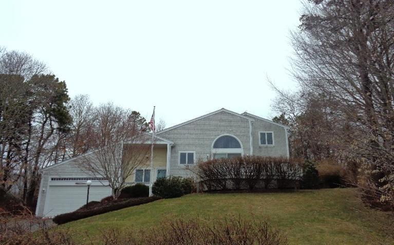 174 Abbey Gate Road Cotuit, MA 02635 - Photo 1 of 4 a front view of a house with garden