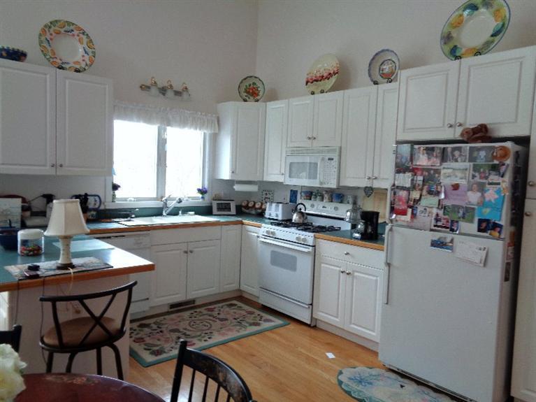 174 Abbey Gate Road Cotuit, MA 02635 - Photo 2 of 4 a kitchen with cabinets appliances a counter top space and a window