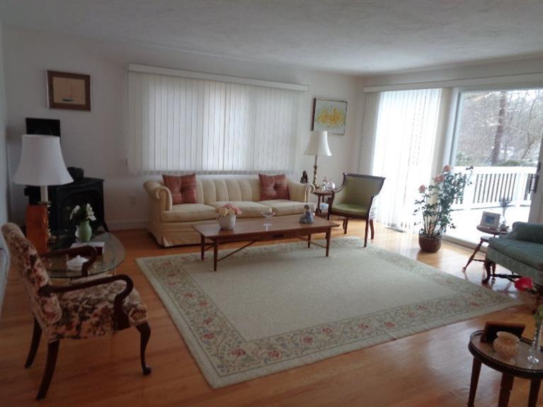 174 Abbey Gate Road Cotuit, MA 02635 - Photo 3 of 4 a living room with furniture and a fireplace
