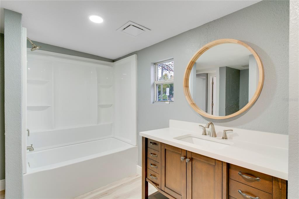330 East Story Road Winter Garden, FL 34787 - Photo 16 of 21 a bathroom with a tub sink and mirror