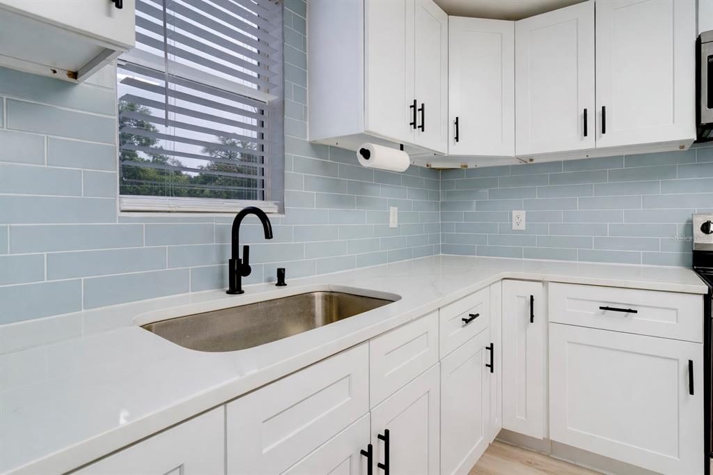 330 East Story Road Winter Garden, FL 34787 - Photo 7 of 21 a kitchen with white cabinets and a sink