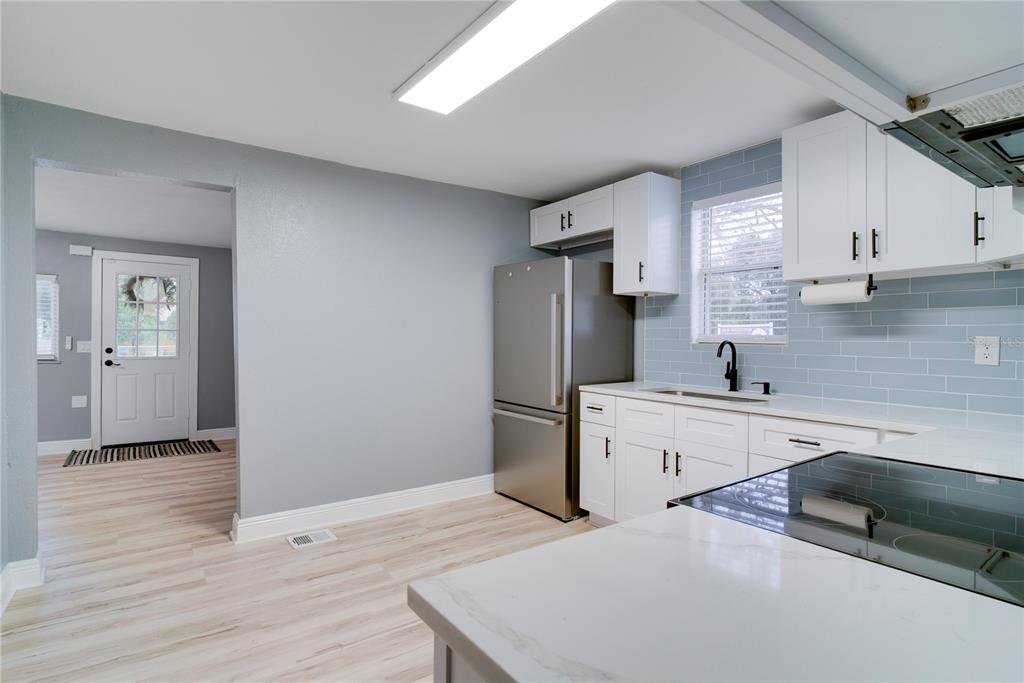 330 East Story Road Winter Garden, FL 34787 - Photo 9 of 21 a kitchen with a sink stainless steel appliances and cabinets