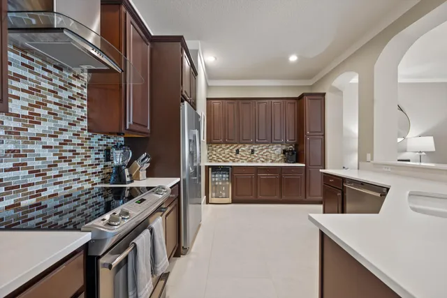 a kitchen with a stove sink and a refrigerator