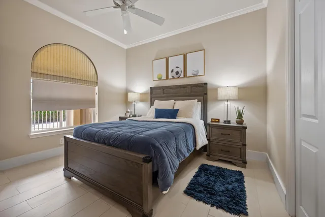 a bedroom with a bed a mirror and window