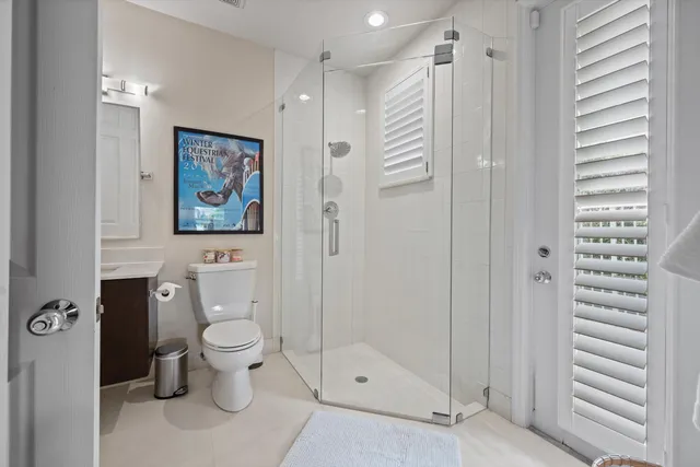 a bathroom with a toilet sink and shower