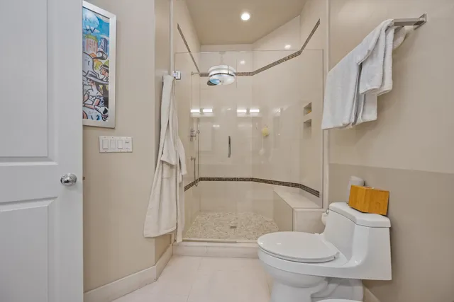 a bathroom with a toilet and a shower