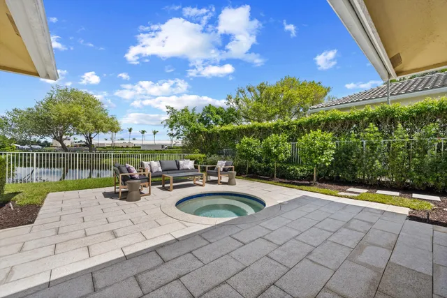 a view of swimming pool with outdoor seating and plants