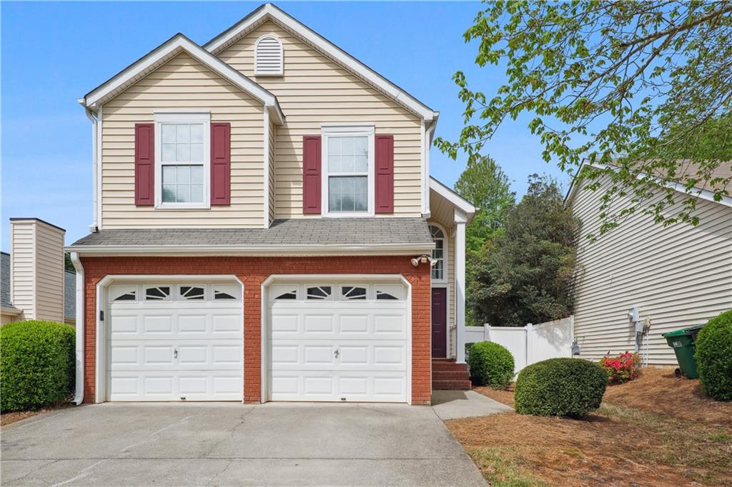 1071 Daventry Crossing Woodstock, GA 30188 - Photo 1 of 1 a view of a house with a yard and garage