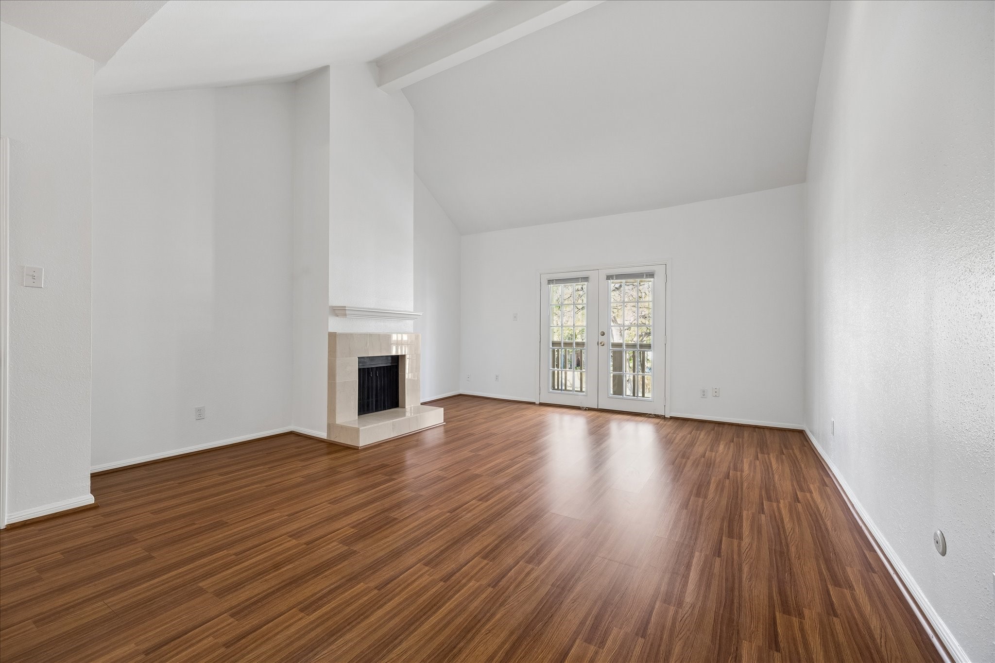 2100 Tanglewilde Street, Unit 286 Houston, TX 77063 - Photo 2 of 22 Soaring Ceiling provides an abundance of light along with the double pane door leading to the covered balcony. Beautiful Laminate Flooring enhances the large room.