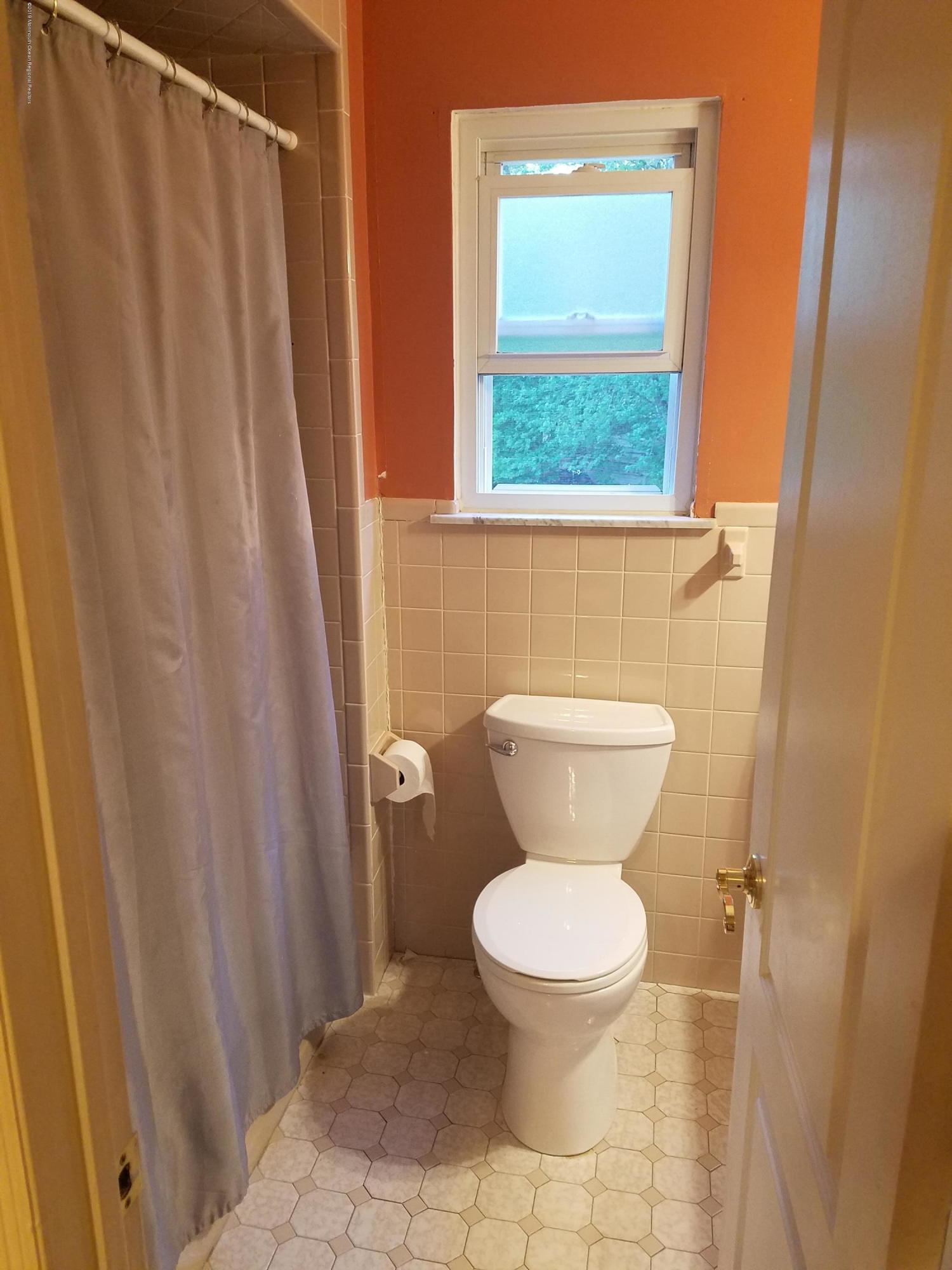 30 Rothbard Road Hazlet, NJ 07730 - Photo 15 of 20 a white toilet sitting next to a sink and a shower