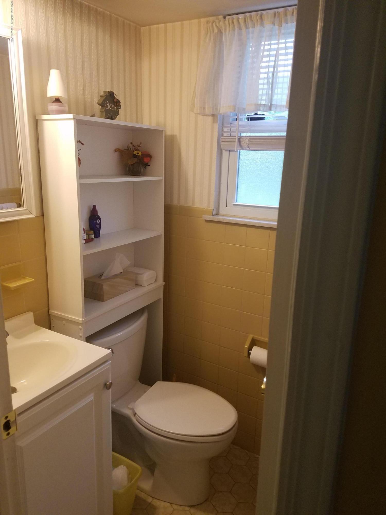 30 Rothbard Road Hazlet, NJ 07730 - Photo 17 of 20 a bathroom with a sink a toilet and window