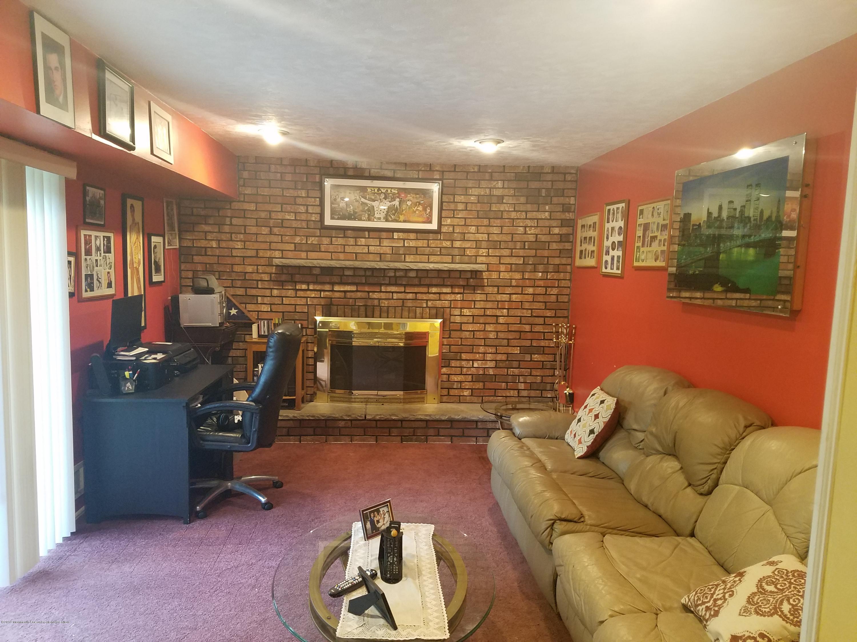 30 Rothbard Road Hazlet, NJ 07730 - Photo 6 of 20 a living room with furniture a rug and a fireplace
