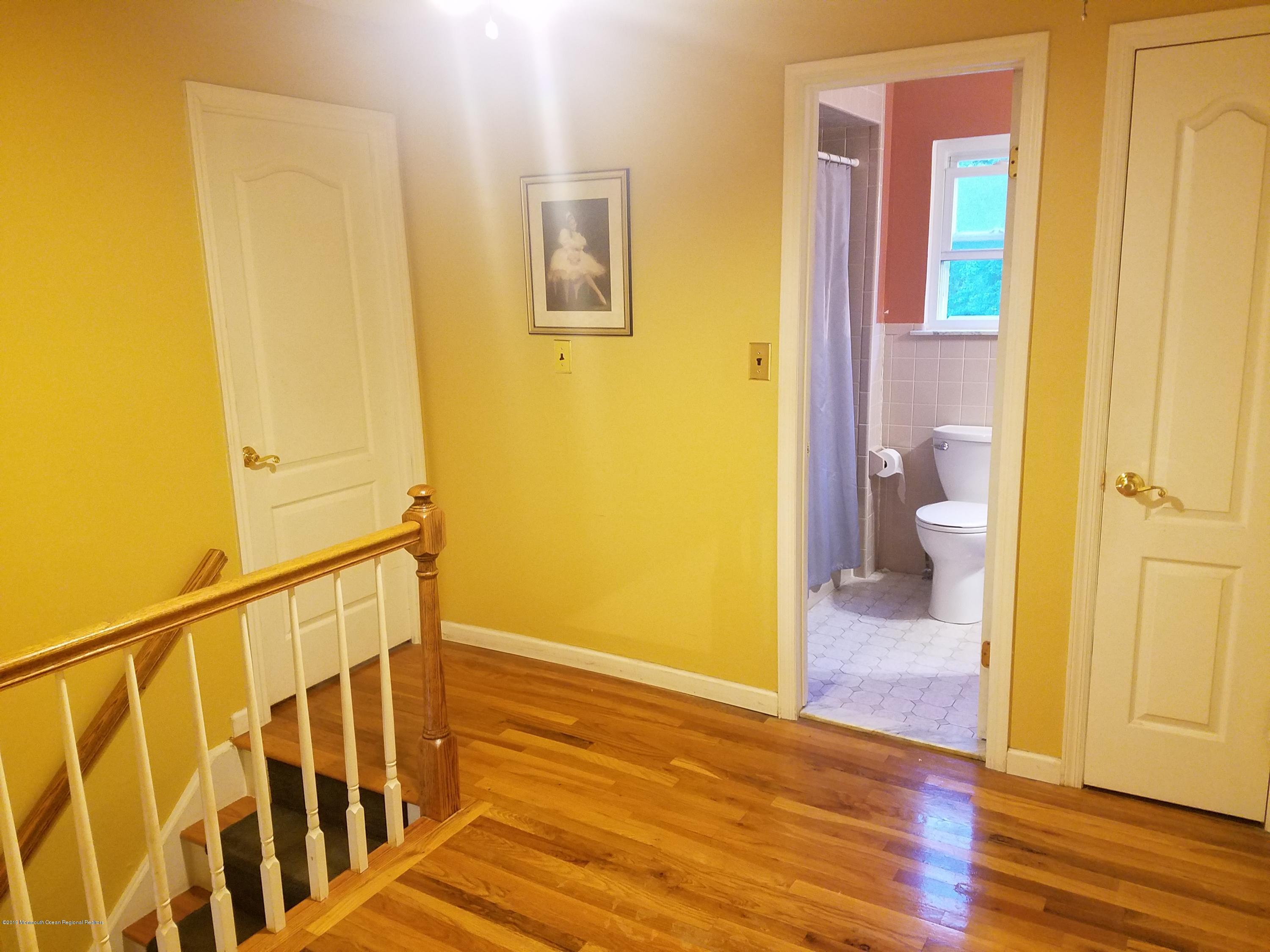30 Rothbard Road Hazlet, NJ 07730 - Photo 8 of 20 a view of an empty room with wooden floor and a bathroom