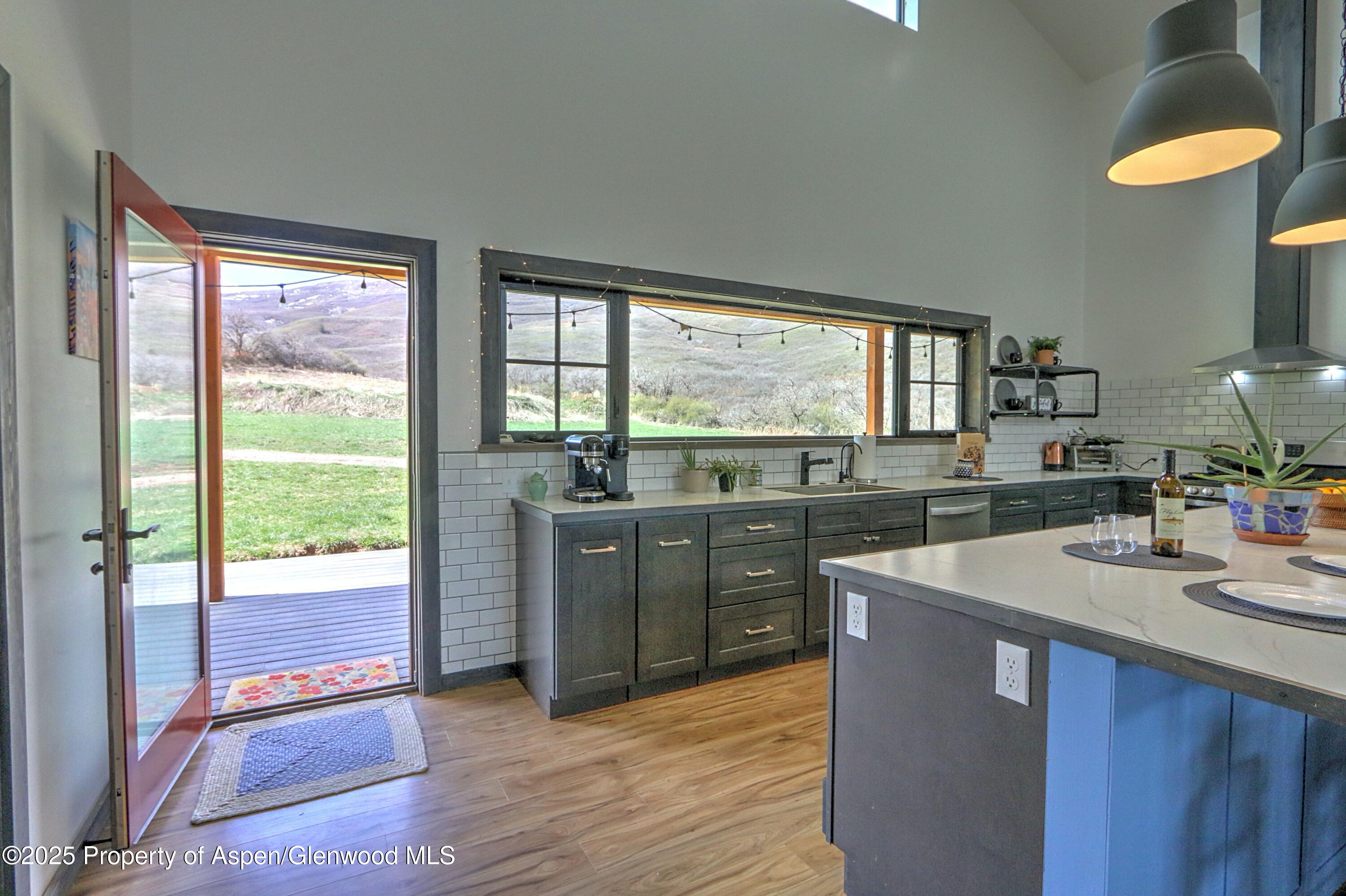 7315 County Road 312 New Castle, CO 81647 - Photo 12 of 75 a kitchen with stainless steel appliances granite countertop a stove a sink and a refrigerator