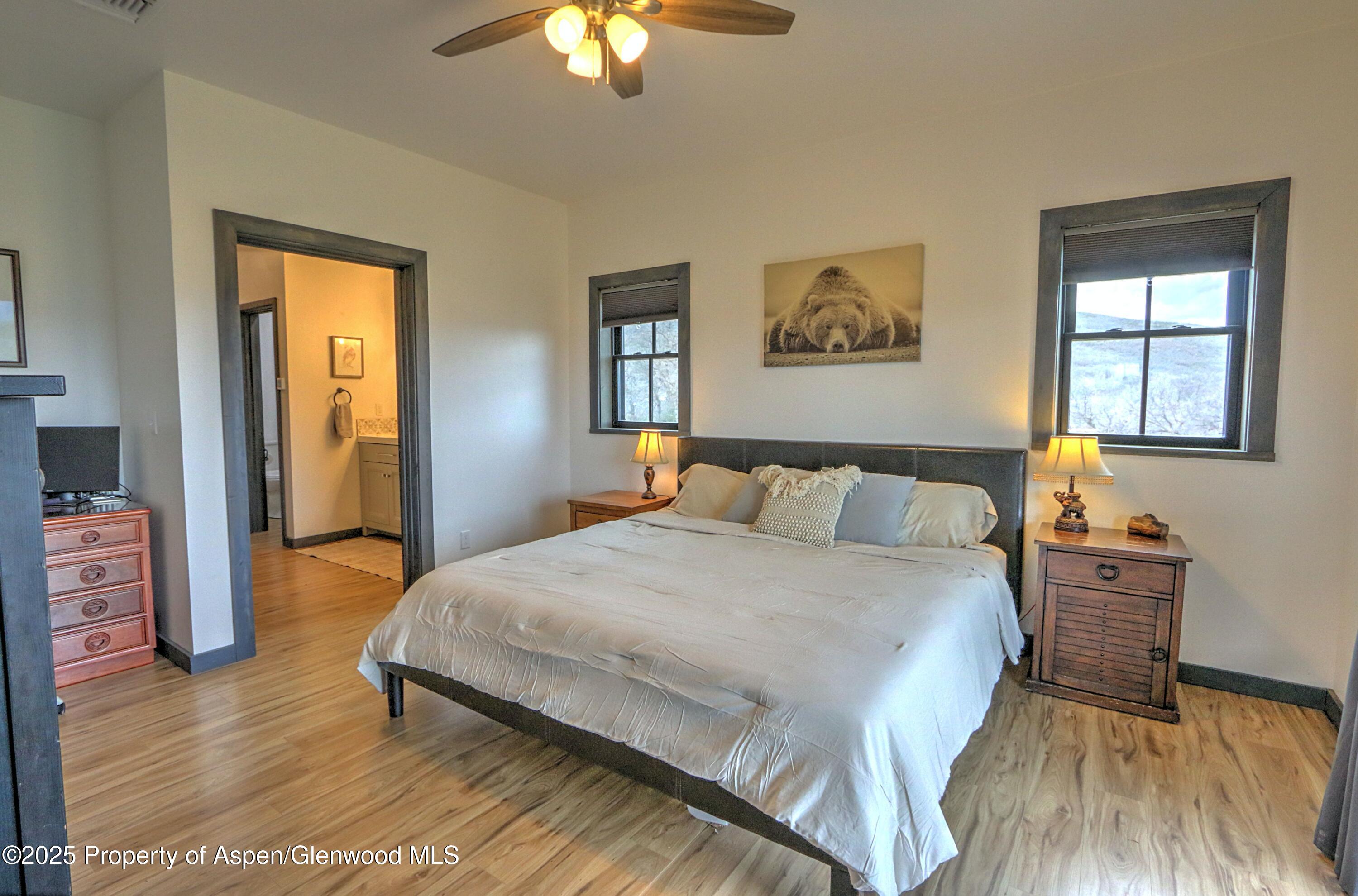 7315 County Road 312 New Castle, CO 81647 - Photo 16 of 75 a bedroom with a bed and a chandelier