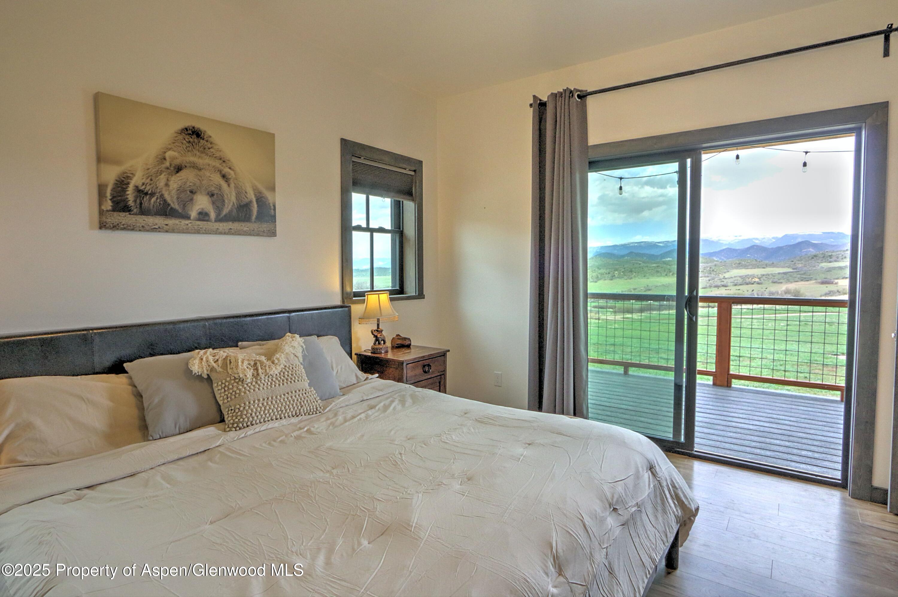 7315 County Road 312 New Castle, CO 81647 - Photo 17 of 75 a bedroom with a large bed and a large window