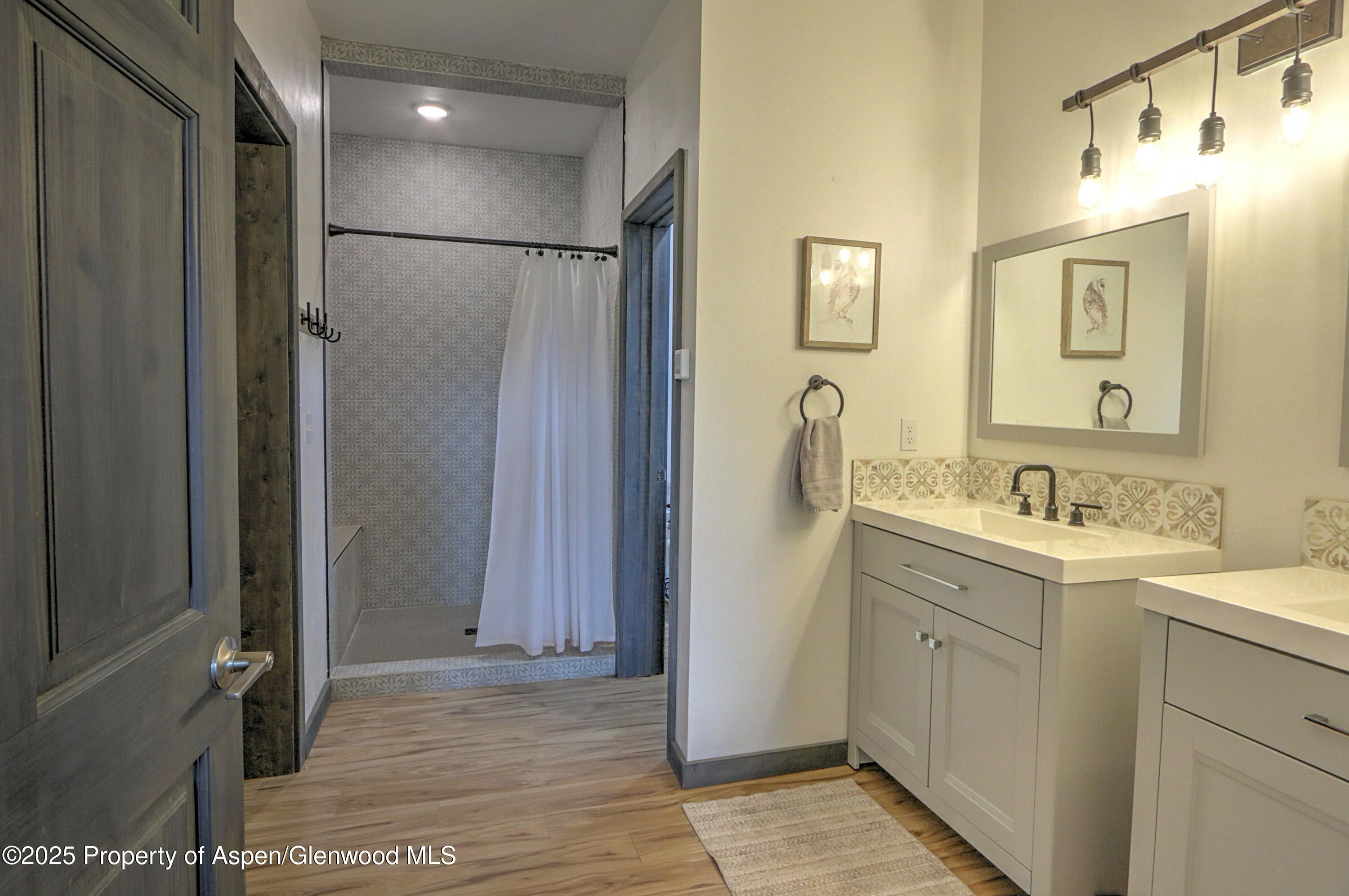 7315 County Road 312 New Castle, CO 81647 - Photo 18 of 75 a bathroom with a double vanity sink mirror and shower